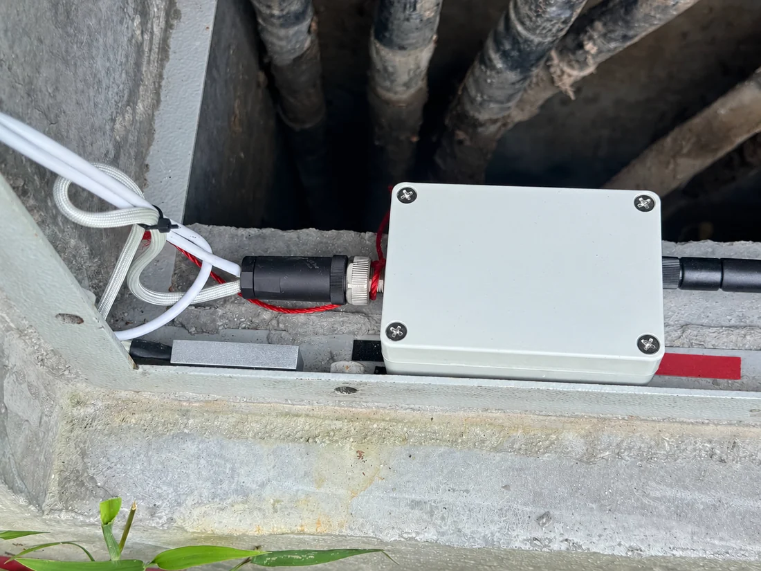Prototype monitoring enclosure, sensor connections and leads; identification redacted