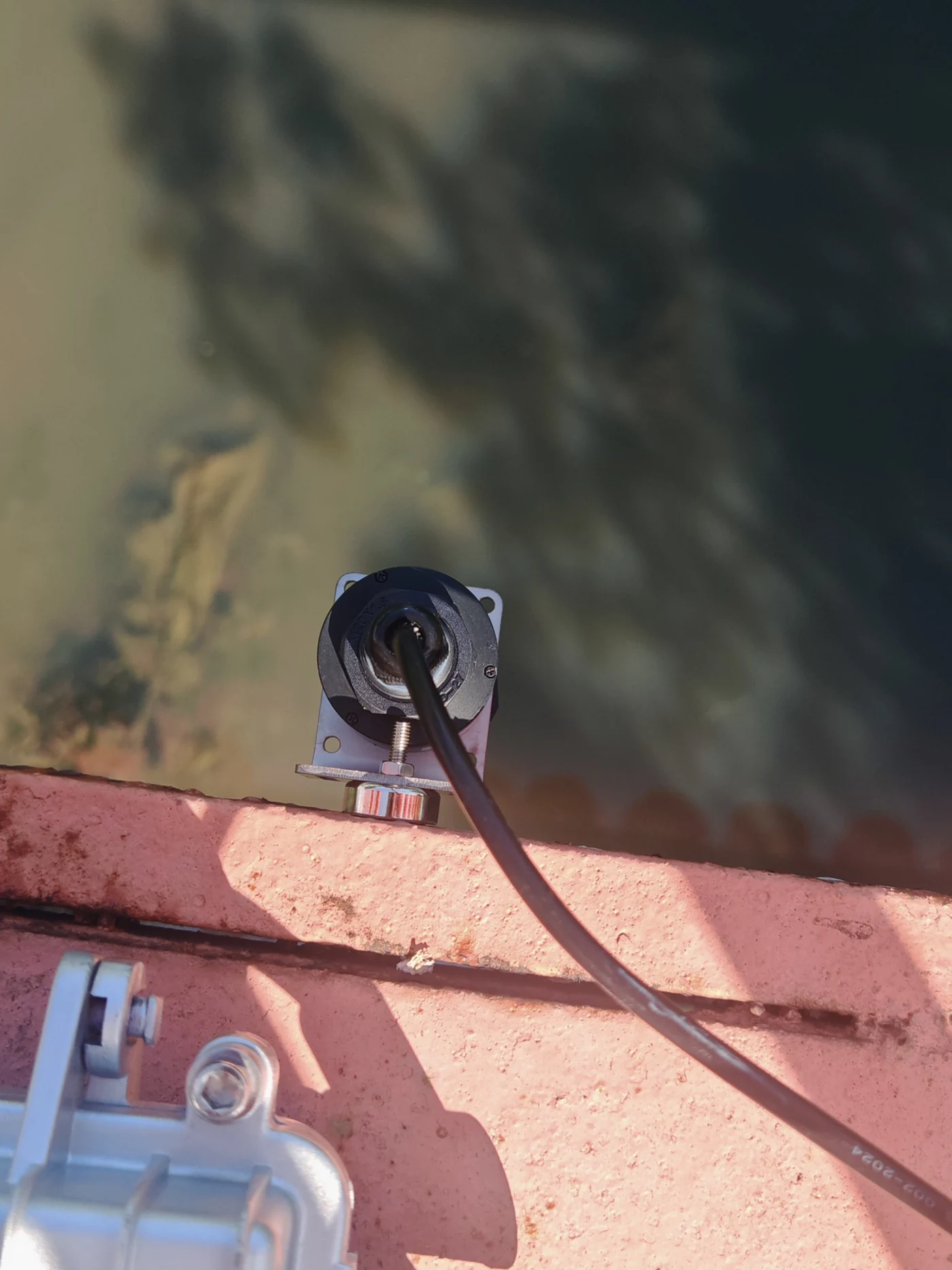 Non-contact radar sensor mounted above a water channel during measurement testing